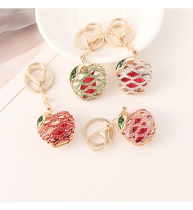 Detailed view of colorful rhinestone apple keychains in gold alloy with gift packaging style