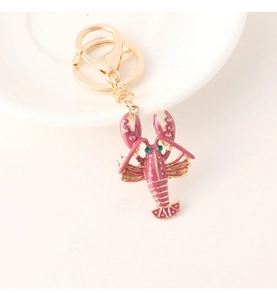 Close-up of rose red enamel lobster keychain with pink crystals and gold-tone hardware