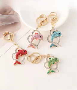 Detailed view of dolphin heart keychains with colorful rhinestones in four vibrant colors