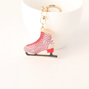 Elegant pink rhinestone ice skate keychain with gold ring and sparkling crystal details