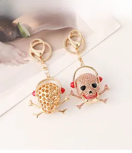 Macro shot of hip-hop skull keychain with red headphones and gold-plated crystals