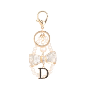 Golden pearl keychain with rhinestone bow and letter D charm for handbags and car keys
