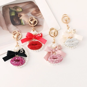 Sparkling rhinestone lip keychains with silk bows and pearl charms in four colors