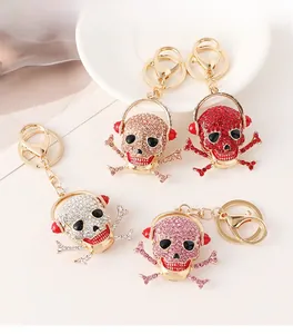 Macro detail of skull headphone keychains in gold finish with multi-color rhinestones