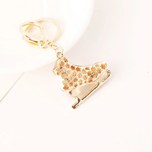 Exquisite golden ice skate keychain with floral patterns and polished finish for car keys
