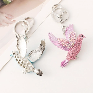 Exquisite flying bird keychain with pink rhinestones and hollow silver metal charm