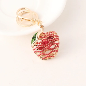 Elegant apple-shaped keychain with red rhinestones and golden hollow metal mesh design