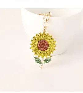 Close-up of sparkling yellow rhinestone sunflower keychain with gold-tone hook detail