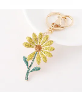Detailed close-up of daisy sunflower keychain with yellow and green rhinestones