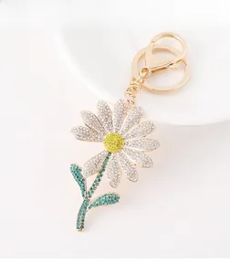 Detailed view of daisy flower keychain with white and yellow sparkling rhinestones
