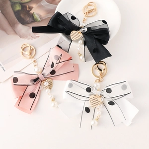 Exquisite mesh bow keychain with pearls and heart charm for bags, available in three colors