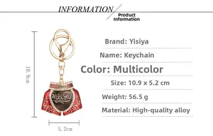 Detail view of Muay Thai shorts keychain with gold alloy finish and red enamel inlay