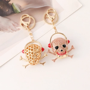 Hip hop skull keychain with red headphones and white rhinestones on gold alloy base