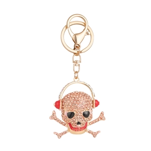 Creative 3D skull keychain with red headphones and champagne crystals on gold plating