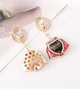 Detail of boxing shorts keychains in gold star pattern and red power motif with rhinestones