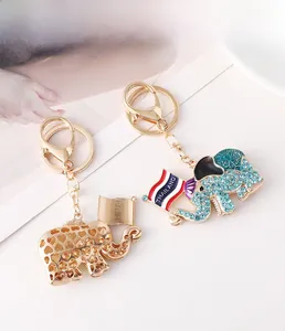 Close-up of elephant keychain with blue rhinestones, enamel floral pattern and Thailand flag
