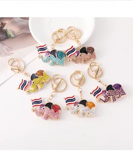 Close-up of Thailand themed elephant keychains with colorful crystals and gold metal finish