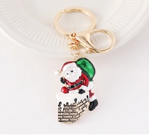 Detail of Christmas Santa Claus climbing chimney keychain with gold lobster clasp