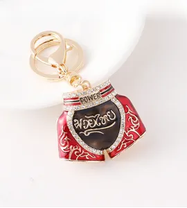 Detail of Muay Thai shorts keychain with red enamel, white rhinestones, and lobster clasp