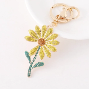 Sunflower keychain with yellow and orange rhinestones on a gold-tone metal ring