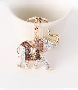 Detailed macro view of gold-plated elephant keychain with sparkling rhinestones and enamel