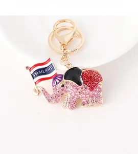 Detailed macro of pink rhinestone elephant keychain featuring a Thailand flag ornament