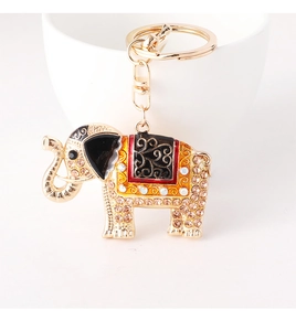 Detailed close-up of golden elephant keychain with colorful enamel and sparkling rhinestones