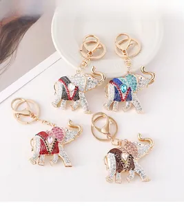 Detail of four colorful enamel elephant keychains with sparkling crystals and gold metal