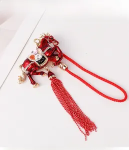 Detail of red zodiac horse ornament with colorful rhinestones and long beaded tassel