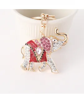 Macro shot of gold elephant keychain with red enamel and sparkling pink rhinestones