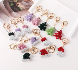 Detailed view of rhinestone Christmas tree and stocking keychains in vibrant colors