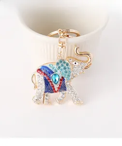 Close-up of golden elephant keychain with sparkling rhinestones and blue enamel inlay