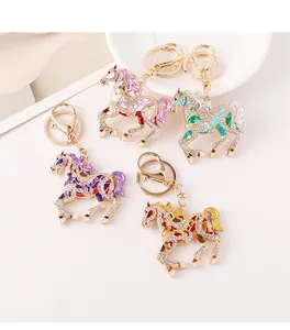 Detailed macro view of enamel horse keychains with sparkling rhinestones and golden rings