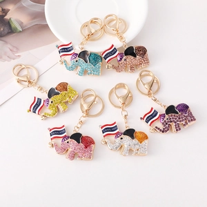 Colorful Thai elephant keychain set with rhinestones and Thailand flag on white background