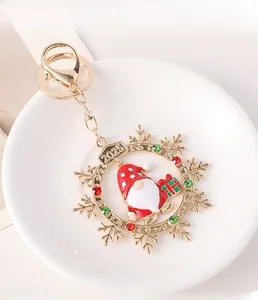 Detail of 2025 Santa Claus snowflake keychain with red gems and gold finish