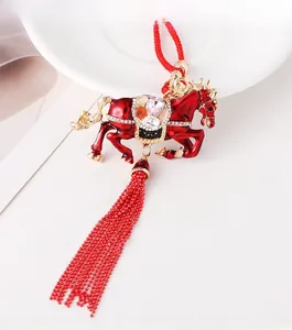 Detailed view of a red Chinese zodiac horse charm with colorful rhinestones and red tassels