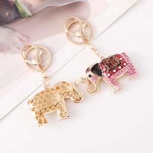 Creative elephant metal keychain set with rhinestones and hollow heart design on white background
