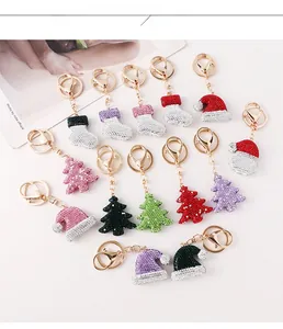 Detailed flat lay of Christmas themed rhinestones keychains with socks and trees