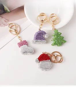 Detailed close-up of sparkling rhinestone Christmas keychains in festive holiday shapes