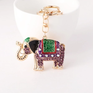 Exotic elephant keychain with purple rhinestones and colorful enamel on white cup