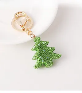 Detail of Christmas tree keychain with sparkling green and colorful rhinestones