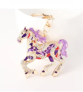 Detail of running horse keychain with purple enamel and sparkling crystal rhinestones