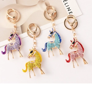 Close-up of diamond-studded horse keychains in purple, yellow, blue, and pink colors