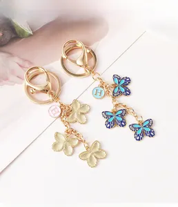 Detailansicht goldener Schmetterlings-Schlüsselanhänger mit blau-lila Emaille-Anhänger
