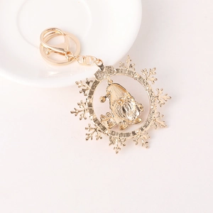 Golden Christmas snowflake keychain featuring a gnome Santa pendant with diamond inlay