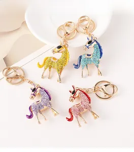 Detail view of colorful rhinestone-encrusted horse keychains in four vibrant colors