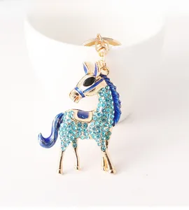 Detail of horse keychain with light blue rhinestones and dark blue enamel details