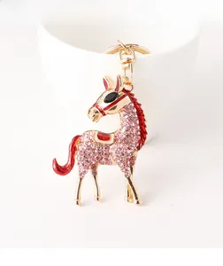 Detailed view of pink rhinestone-encrusted horse keychain with red enamel and gold finish
