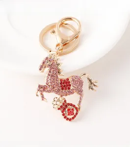 Detailed macro of golden horse keychain with sparkling pink and red rhinestones