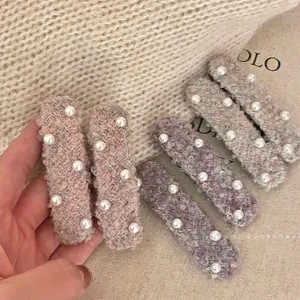 Pink tweed hair clips set with white pearl embellishments for an elegant vintage style